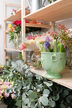 Different varieties. Fresh spring flowers in refrigerator for flowers in flower shop. Bouquets on shelf, florist