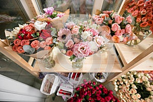 Different varieties. Fresh spring flowers in refrigerator for flowers in flower shop. Bouquets on shelf, florist