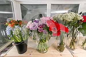 Fresh spring flowers in refrigerator for flowers in flower shop. Bouquets on shelf, florist business.