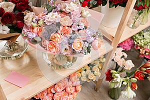 Different varieties. Fresh spring flowers in refrigerator for flowers in flower shop. Bouquets on shelf, florist