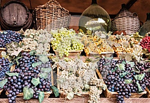 Different varieties of grapes in the wicker baskets, market place