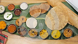 Different varieties of tasty South Indian food being served on a banana leaf