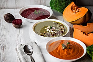 Different vegan food. Colorful vegetables cream soups and ingredients for soup. Healthy eating, dieting, vegetarian