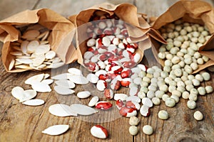 Different vegetable seeds on wooden table