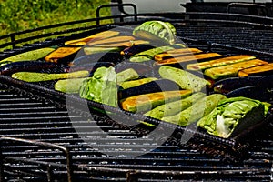 Different vegetables cooking on a grill at country fair