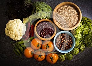 Different vegetables, fruits, cereals frame the old background