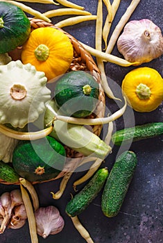 Different vegetables, small patissons, along with other vegetables, cauliflower, broccoli, garlic, cucumbers grown on an eco-farm