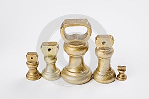 Different vintage brass weights unit standing