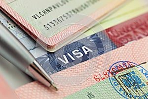 Different visas and stamps in a passport background