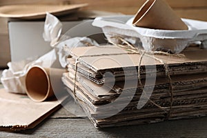 Different waste paper on wooden table, closeup. Space for text