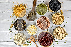 Different whole grains beans on bowl and legumes seeds lentils and nuts colorful snack background top view - Collage various beans