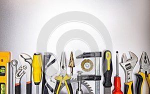 Different work tools on gray metal surface. industrial background