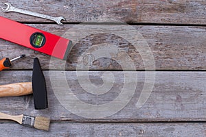 Different working tools on rustic wooden boards.