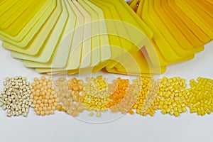 different yellow plastic polymer resin granulates with samples in laboratory