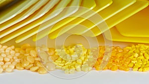 different yellow plastic polymer resin granulates with samples in laboratory