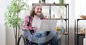 Differently abled man video conferencing using laptop