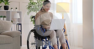 Differently abled woman on wheelchair working with laptop