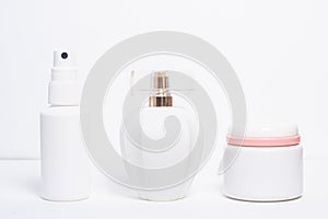 Differently shaped white cosmetic bottles