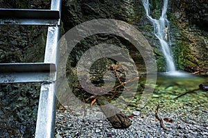 Difficul trail with ladder near the waterfall in canyon of National park Slovak paradise