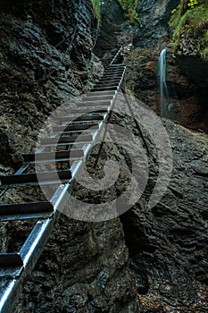 Difficul trail with ladder near the waterfall in canyon of National park Slovak paradise