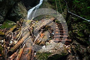 Difficul trail with ladder near the waterfall in canyon of National park Slovak paradise