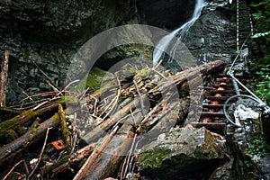 Difficul trail with ladder near the waterfall in canyon of National park Slovak paradise, Slovakia