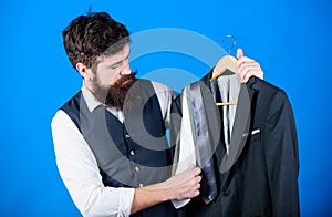 Difficulty choosing necktie. Shop assistant or personal stylist service. Matching necktie outfit. Man bearded hipster