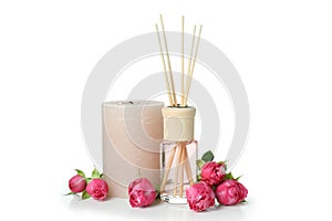 Diffuser bottle, roses and candle isolated on white background