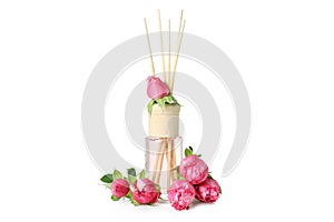 Diffuser bottle with roses isolated on white background