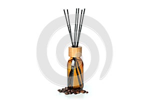 Diffuser bottle with sticks and coffee beans isolated on white background