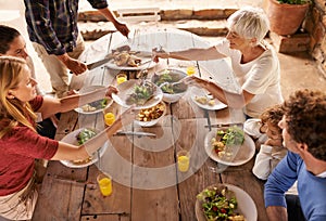 Dig in. A view of a family preparing to eat lunch together outdoors.