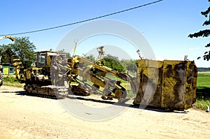 Digger digs a trench for pipe laying