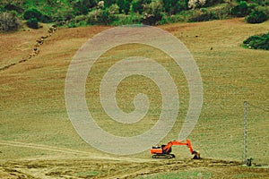 Digger excavator on field