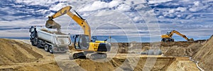Digger and excavator at work in construction site