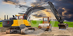 Digger and excavator at work in construction site