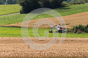 Digger with hut and earth on a corn field rural landscape