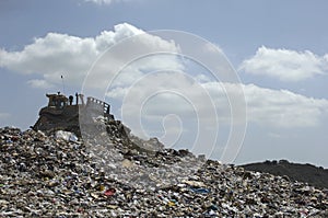 Digger At Landfill Site