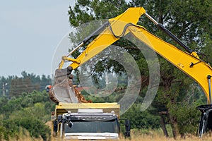 Digger loading soil onto a truck