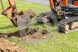 Digger machine operate for digging soil and repair road in the p