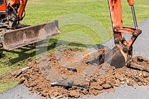 Digger machine operate for digging soil and repair road in the p