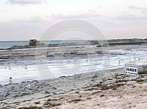 Digger moving beach sand after erosion in Palm Beach, Florida