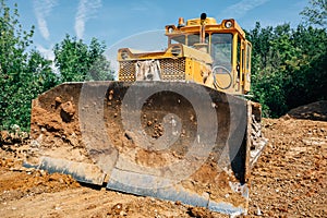 Digger in quarry, heavy duty yellow excavator