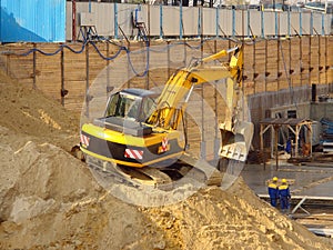 Digger on sand heap photo