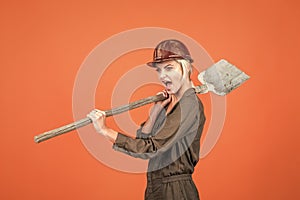 digger. woman in boilersuit and helmet. female builder hold shovel. building and construction.