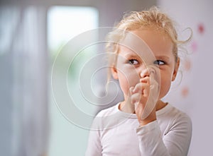 Digging for gold. A little girl picking her nose.