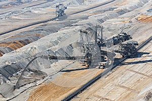 Digging machine busy with deposit soil in Hambach mine Germany photo