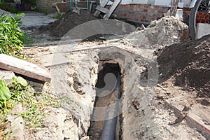 Digging a trench for a main drain pipe, sewer line to a sewer or septic tank. Sewer line replacement or repair