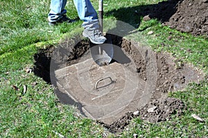 Digging up the lawn to prepare a septic tank for maintenance.