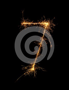 Digit 7 or seven made of bengal fire, sparkler fireworks candle isolated on a black background