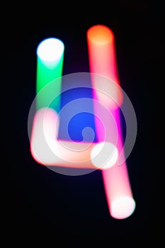 Digit 4. Four. Glowing numbers on dark background. Abstract light painting at night. Creative artistic colorful bokeh. New Year.